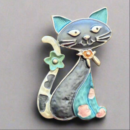 Magnetic Cat Brooch with very strong magnetic – no pins required – for easy placement and damage free removal. Purrrfect addition to brighten up coat, cardigans, ponchos or fixing a wrap or scarf. It is beautiful on hat and bags too, not thicker than 3 – 4 mm and makes a very nice gift for many occasions. Available in blue, black/gold, multicolour and bronze