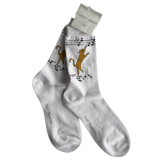 white socks with super cute ginger cat dancing and pawing at music notes