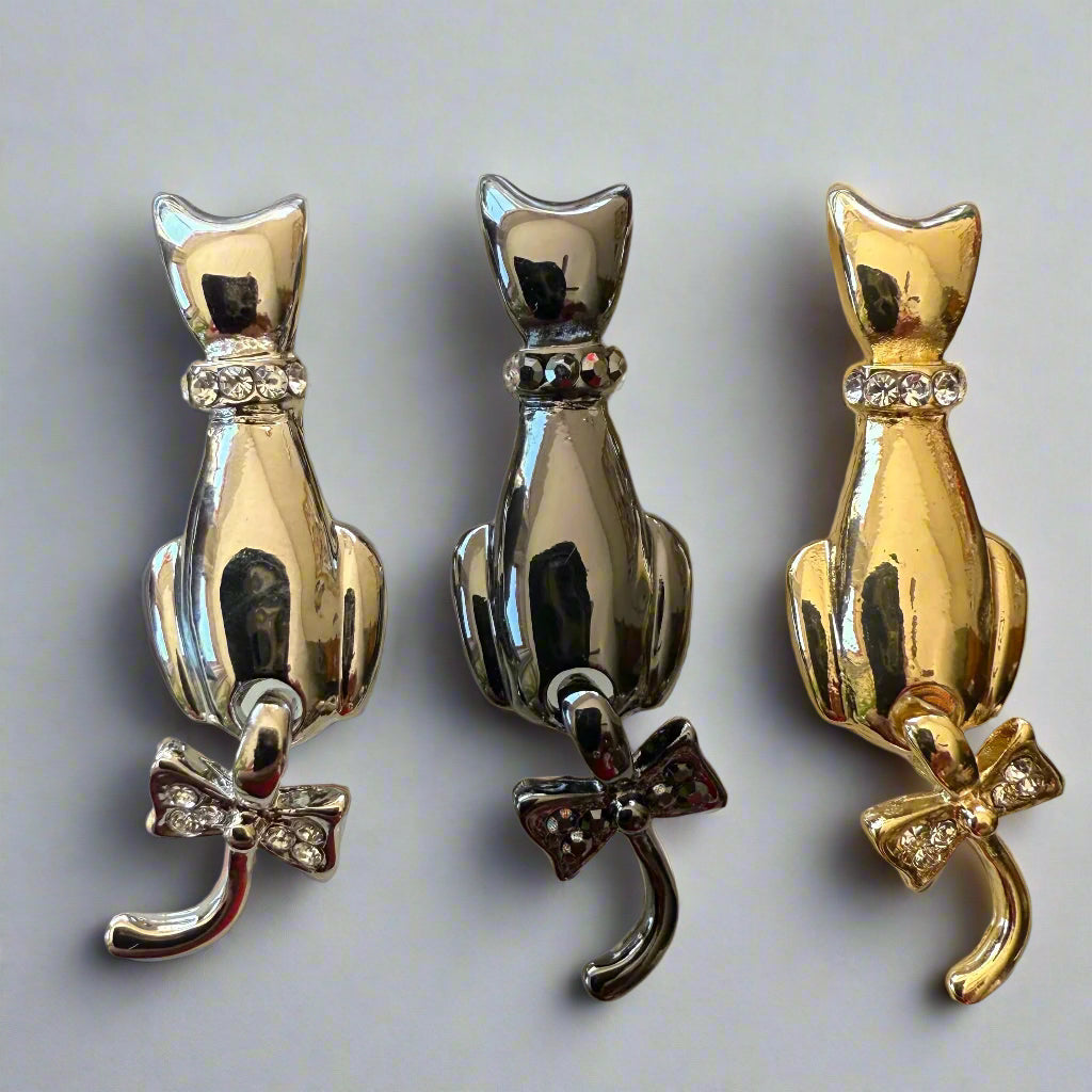super cute swinging tail cat brooch seen here in 3 available colours: silver, black or gold