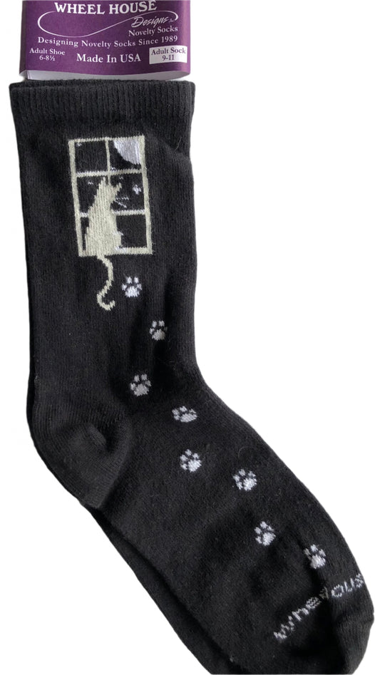 wheel house brand black crew sock with cat looking out the window at the moon, cute white paw prints all the way down to the toes
