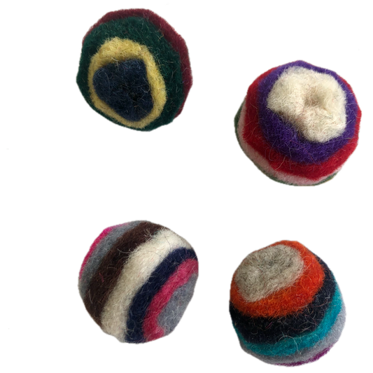 4 multicoloured cat toy balls, made out of  layered wool, are small enough for a cat to pick up with their mouth to carry or toss, they like bat them around and chase them. The layers of wool create a striped pattern which makes the ball more visually enticing as it rolls. Many cats have a natural attraction to the scent of wool. The balls are under an inch (2.5 cm) in diameter, just a little bit bigger than a quarter