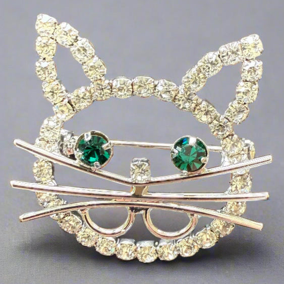 cute rhinestone outline of a cat with green eyes and silver whiskers
