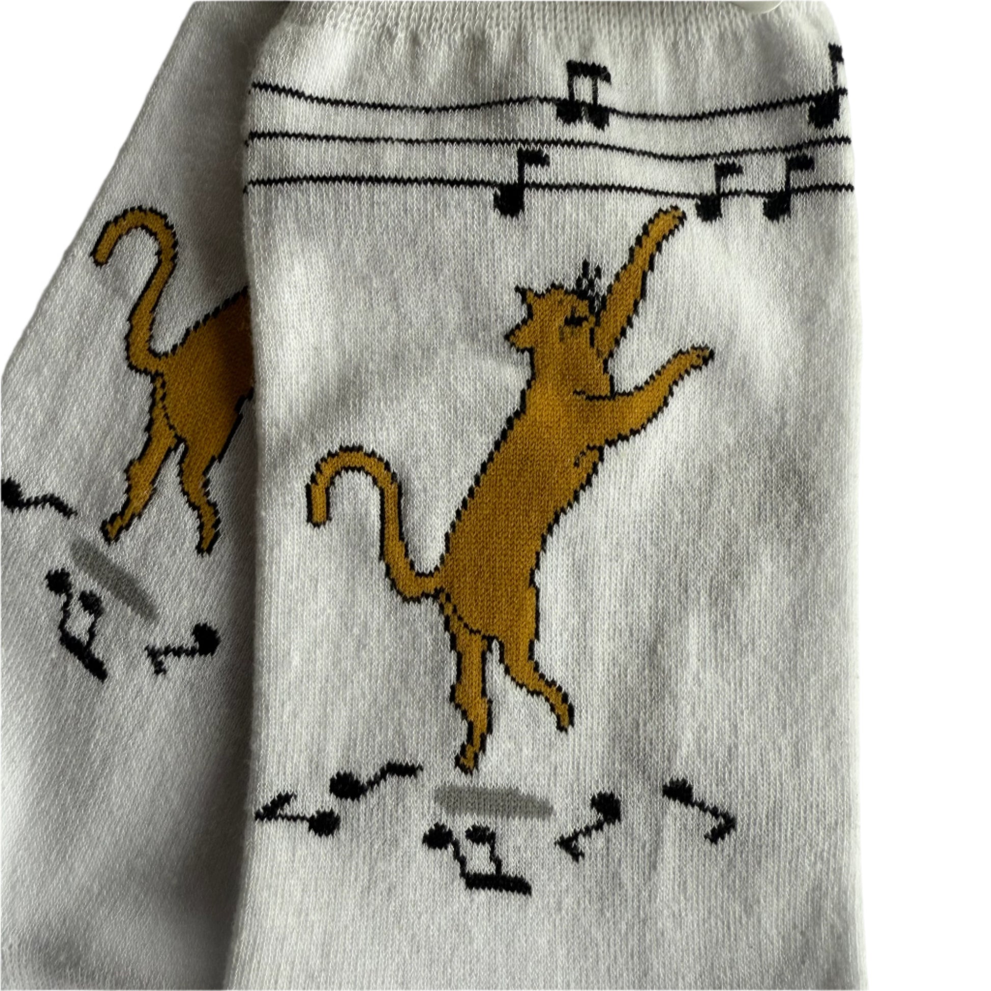 white socks with super cute ginger cat dancing and pawing at music notes, this is closeup