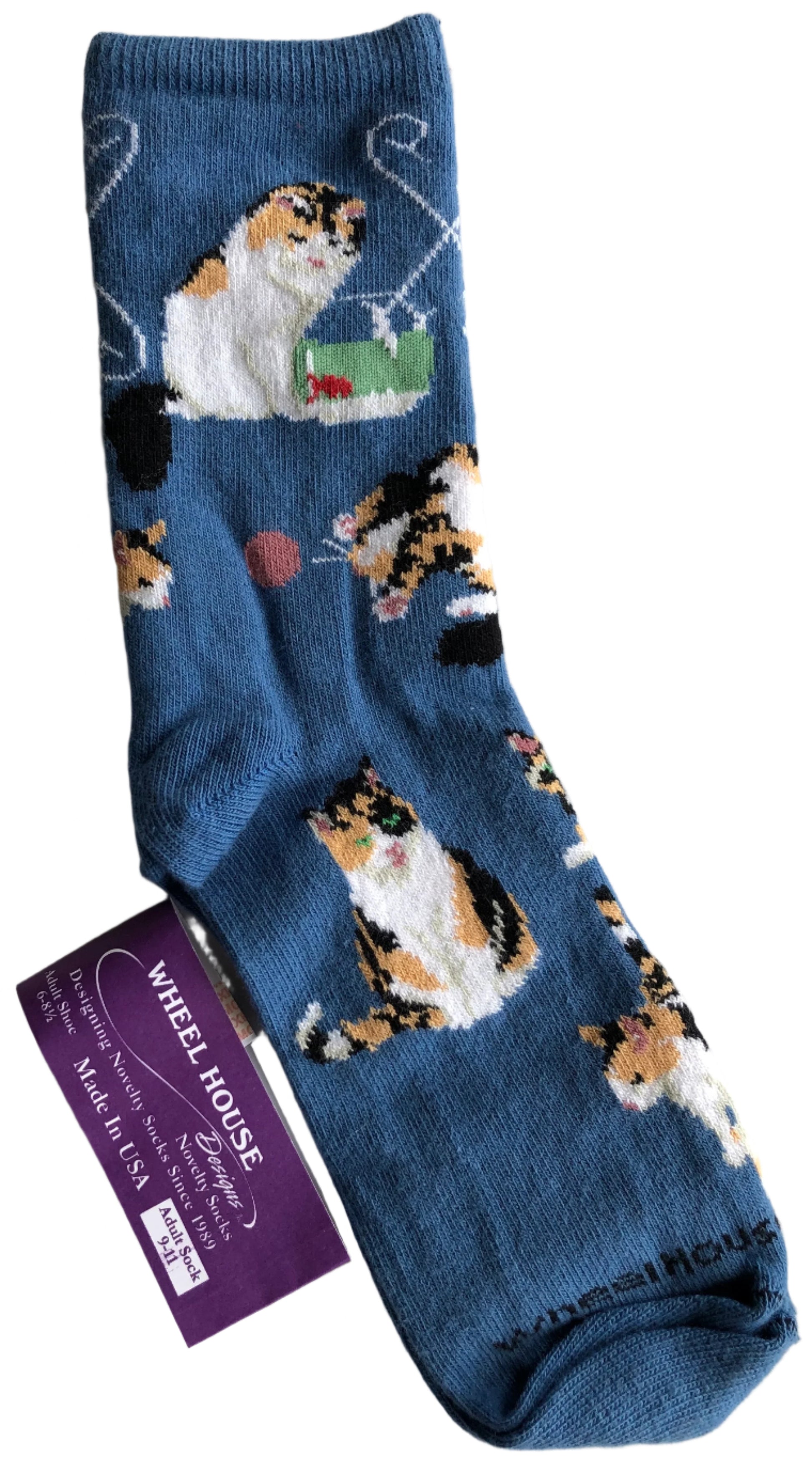 periwinkle blue crew sock with calico cats playing all over - chasing ball, fishing, siting beautiful with green eyes