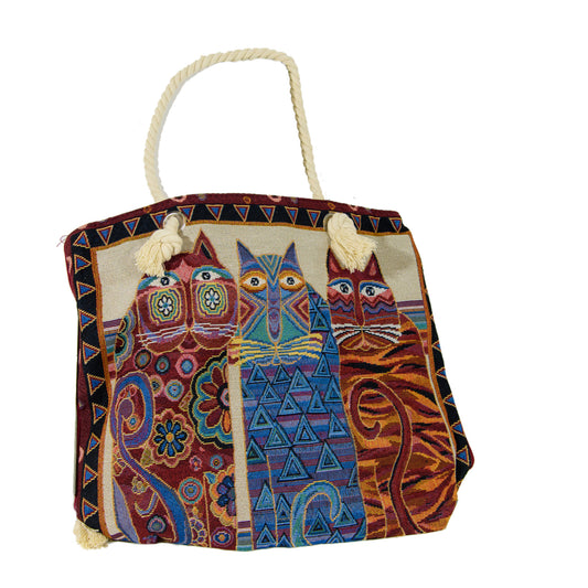 Iconic Laurel Burch cats on one side, solid red on the other; available in a variety of colours including black, sage green and navy. Sturdy and well-made with inside pocket. Measures 17” x 14”.